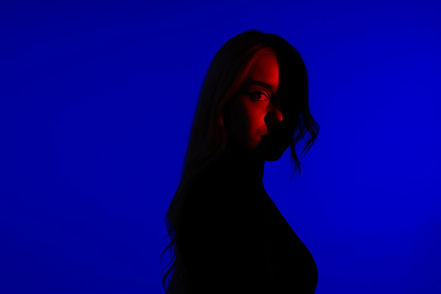 Woman Portrait Illuminated by Red Light on Blue Background