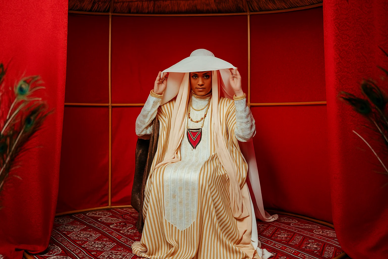 Traditional Elegance: Woman in Cultural Attire Inside a Red Tent