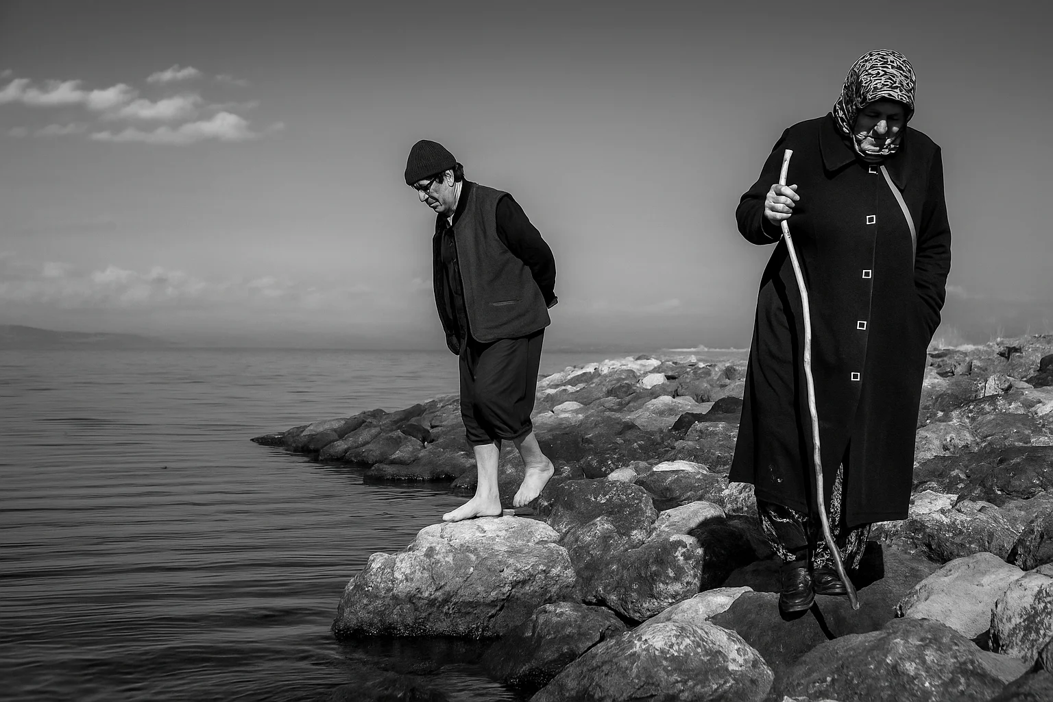 Elderly Couple Walking by the Seaside
