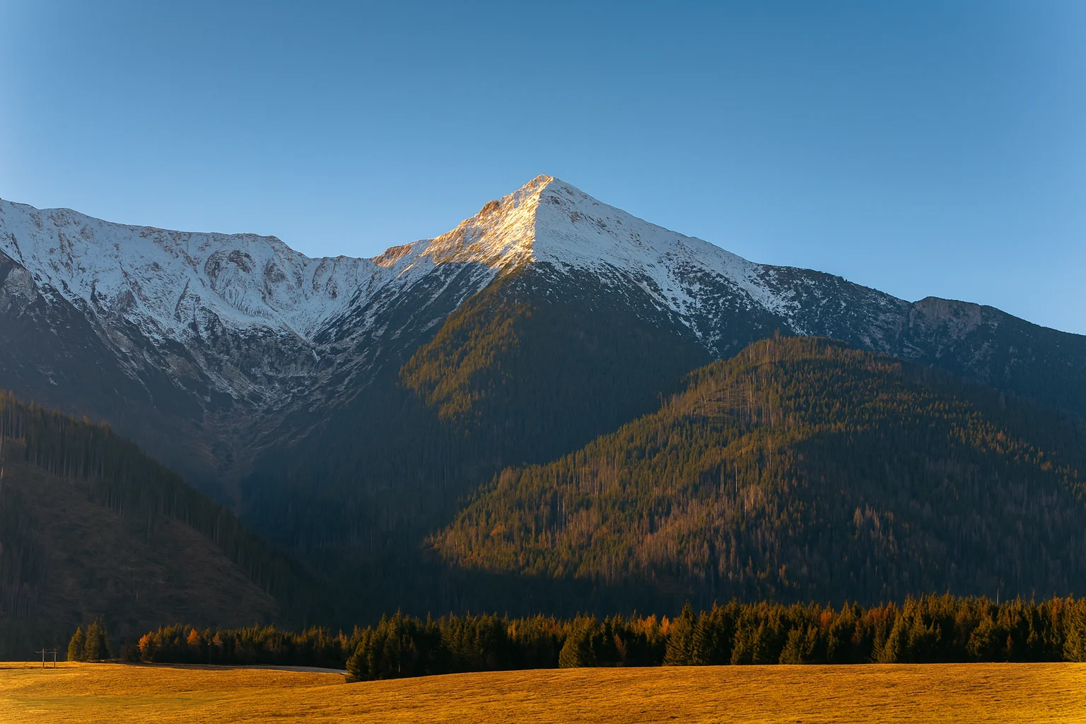 Golden Sunlit Snowy Mountain Peak Landscape