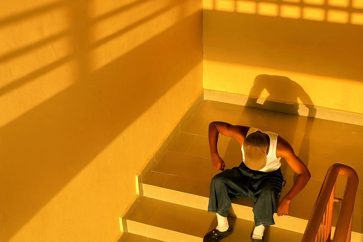 Person Sitting on Stairs in Golden Hour Light