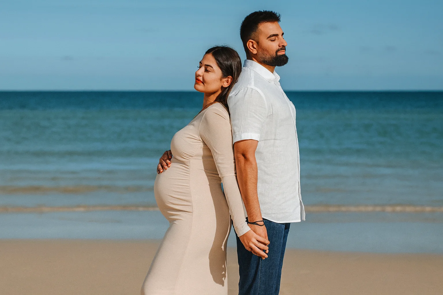 Maternity Couple Portrait Holding Hands on the Beach